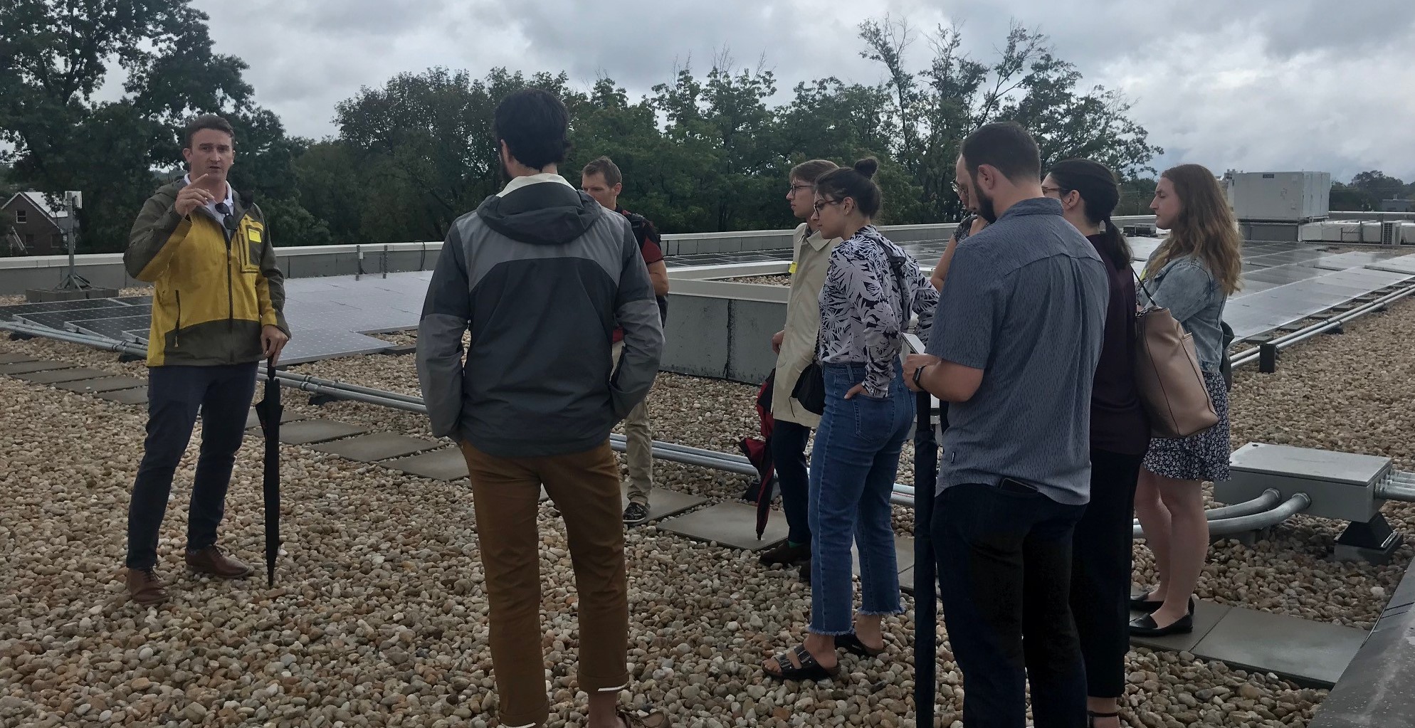 Congressional Staffers learning about rooftop solar array on Capital City Public Charter School