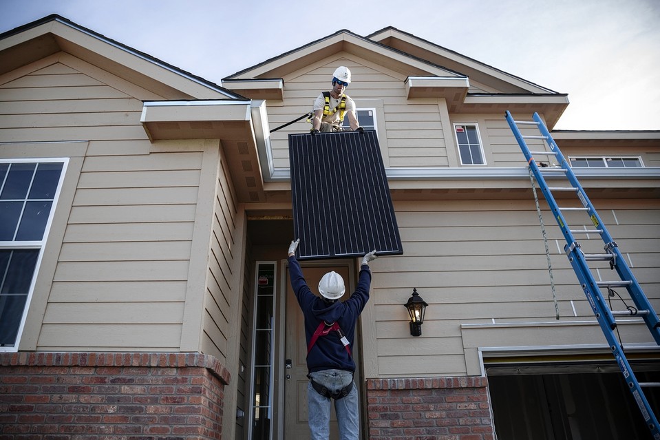 Workers install solar panels to generate electricity at a Lennar house in Castle Rock, Colo., last week.