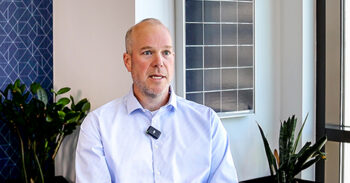 Still of Kevin Lucas speaking about the grid